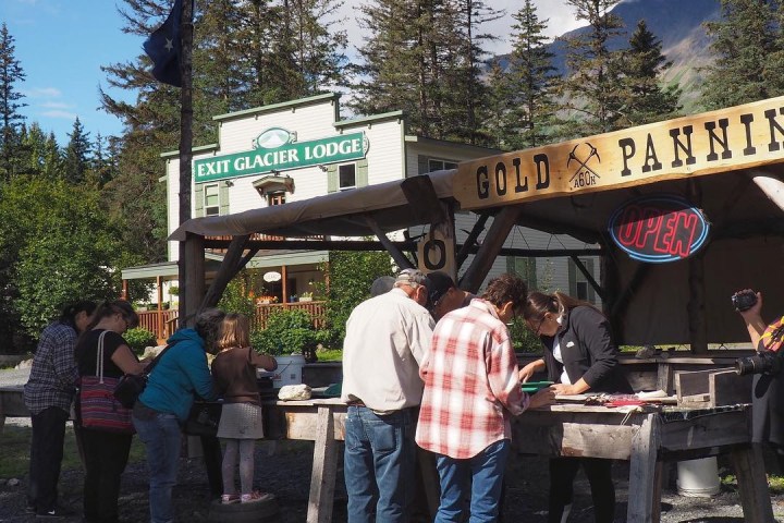 a group of people standing in front of a sign