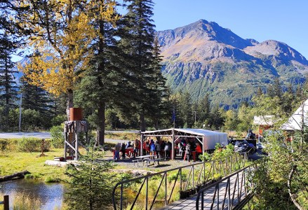 a group of people on a train track with trees in the background