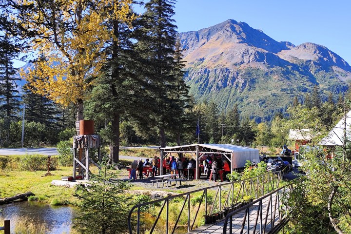 a group of people on a train track with trees in the background