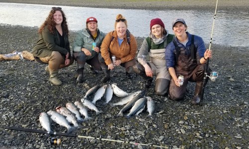 a group of people sitting on a fish in the water