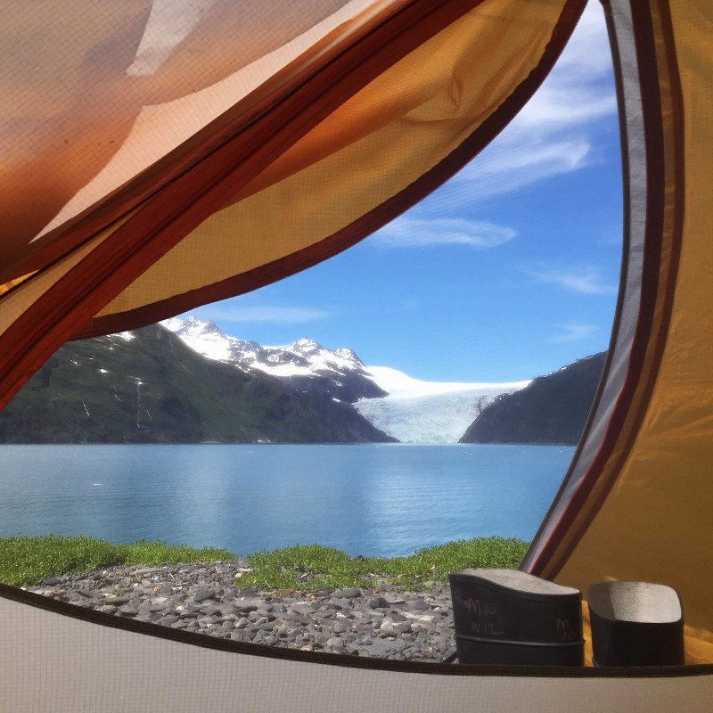 View of glacier and lake from inside a tent.